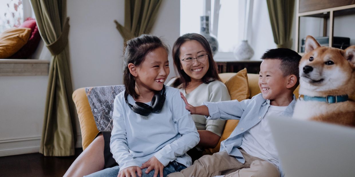 Family sitting on couch financial planning