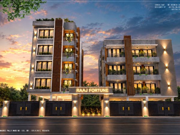 Modern apartment complex at sunset with illuminated signage.