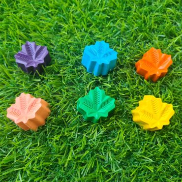Colorful leaf-shaped objects on grass.