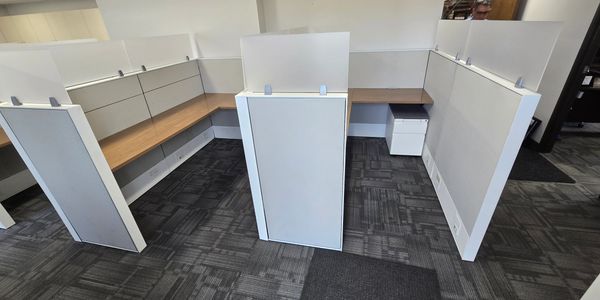 “Used Haworth 5x7 cubicle with 67 inch panels and frosted glass stackers, wood work surfaces"