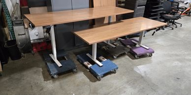 2 30"x84" Used Haworth electric sit-to-stand desks in warehouse in Vancouver WA 
