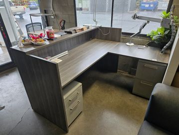 reception desk setup with new desk and used Haworth storage components
