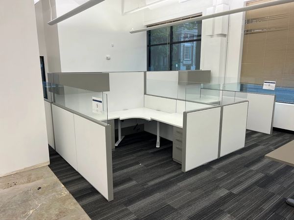 customized Haworth cubicles – new fabric panels, new desktops, corner sit-to-stand stations.