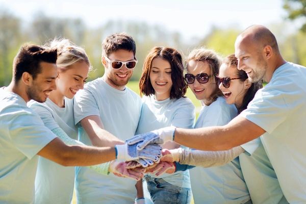 Group of people placing hands on each other