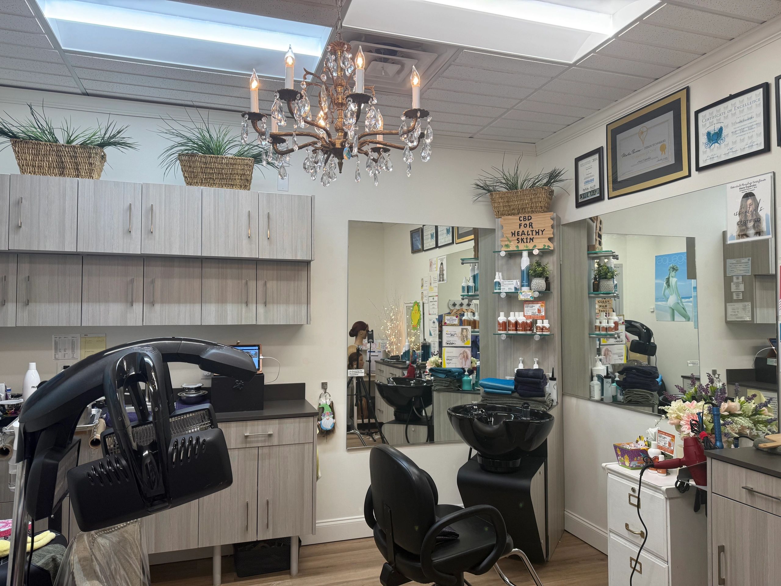Interior of a hair salon with chairs and hair washing stations.