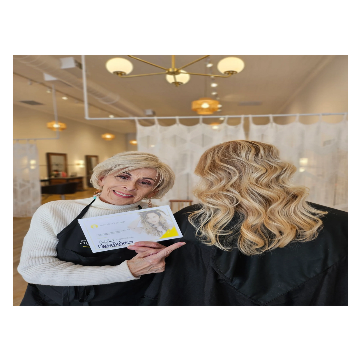 A woman points to her hair