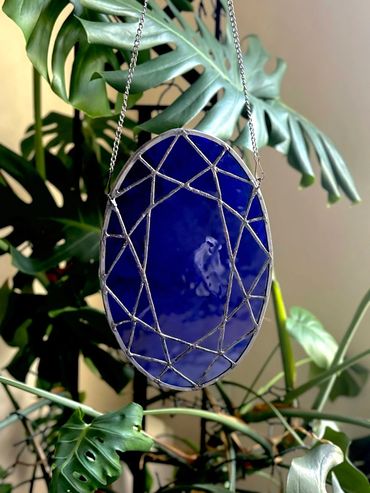 Dark blue oval sapphire gemstone inspired stained glass piece