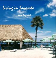 Sunny beach scene in Sarasota with umbrellas and palm trees.