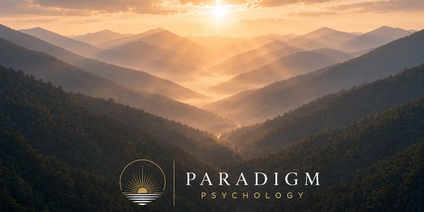 Sunrise over misty mountains with Paradigm Psychology logo.