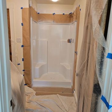 Bathroom shower area masked and covered for resurfacing/refinishing.