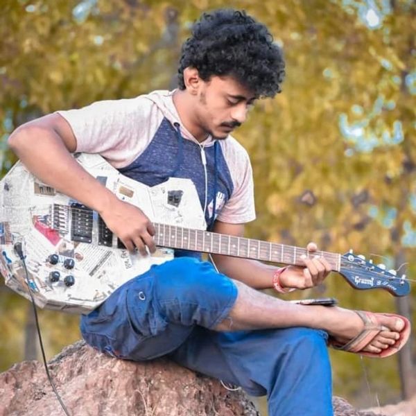 Anik deb is playing guiter for "Purulia Tour Plan"