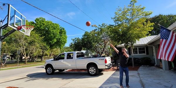 A man throwing basketball into the basket