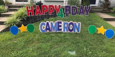 Colorful birthday lawn signs for Cameron's 4th birthday celebration.