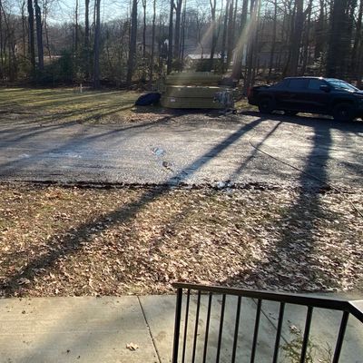 Muddy regions on both sides of the driveway, right off the front steps.