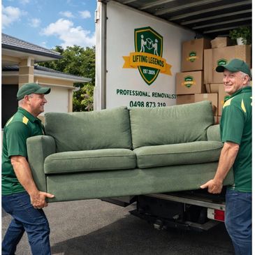 Professional furniture removalists loading a sofa into a moving truck. Experienced movers 