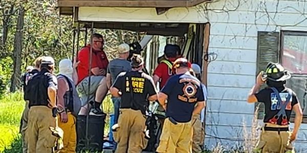 Firefighters rescue a person from a building.