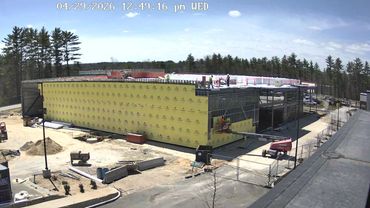 Construction site of a large building on a sunny day.