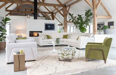 Spacious modern living room with neutral tones and green accents.