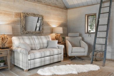 Cozy living room with plaid sofa and armchair.