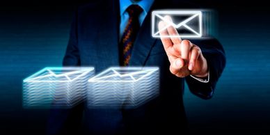Business professional selecting digital email icons representing secure archiving and retention.