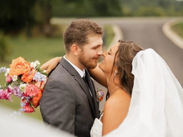 A bride and groom smiling affectionately on their wedding day.