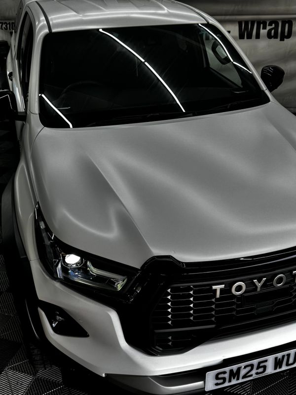 Front view of a sleek silver Toyota vehicle with modern headlights.