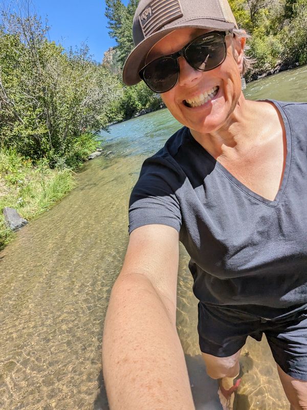 Terrie standing in a stream.