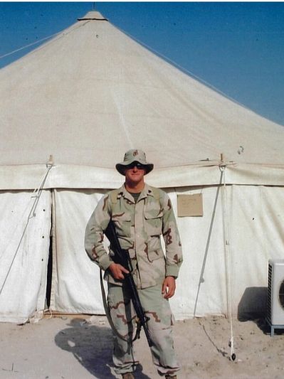 male Marine in uniform holding a weapon