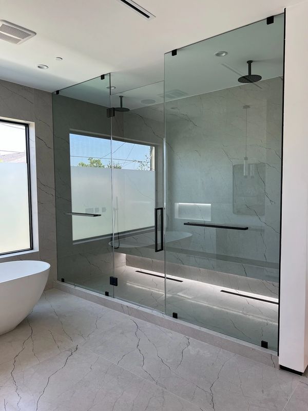 Beautiful primary shower enclosure with matte black iron hardware