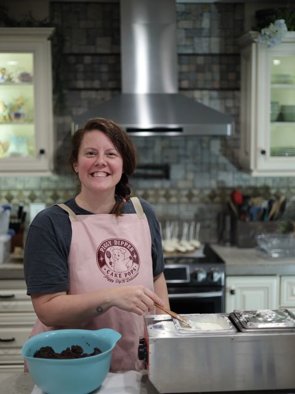 Jana, owner of Piggy Dipper Cake Pops, preparing handcrafted cake pops in her home kitchen in Centra