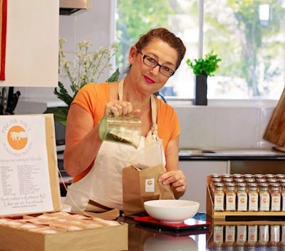 Julie creating blends with herbs spices and seasonings  in the Pincha Salt Kitchen.