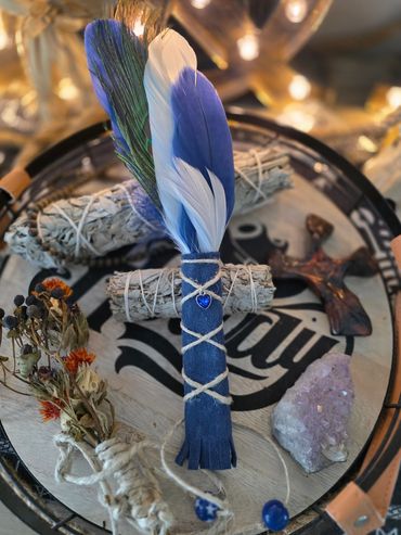 Decorative bundle with blue feathers and crystals.