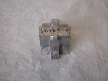 A small metallic object with markings on top.