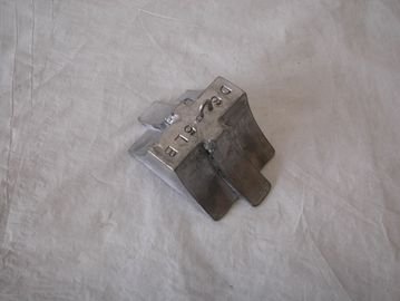 Metal bracket with mounting holes.