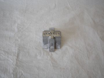 Small metallic object with numbers on top.