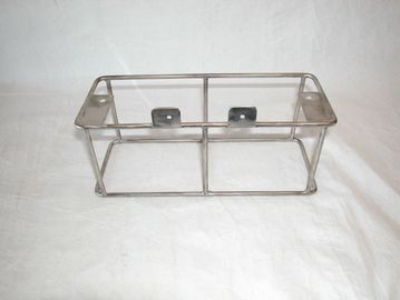 Metal wire rack with two clips on a plain background.