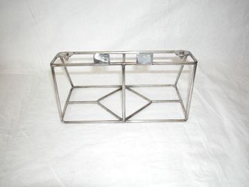 Metal wireframe holder on a white surface.