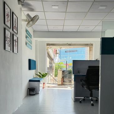 Modern office space with a chair, desk, and wall art.