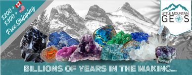 Various vibrant gemstones displayed with mountain background.