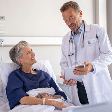 Photo of a doctor speaking with a patient in a hospital bed