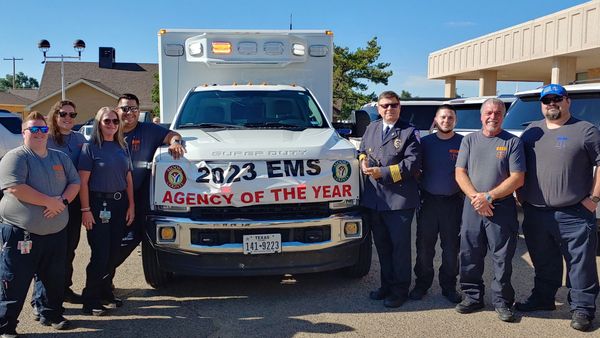 Photo of the MCHD EMS crew standing in front of an ambulance.