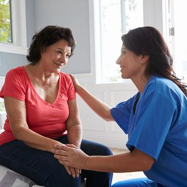 Image of a nurse comforting a senior patient