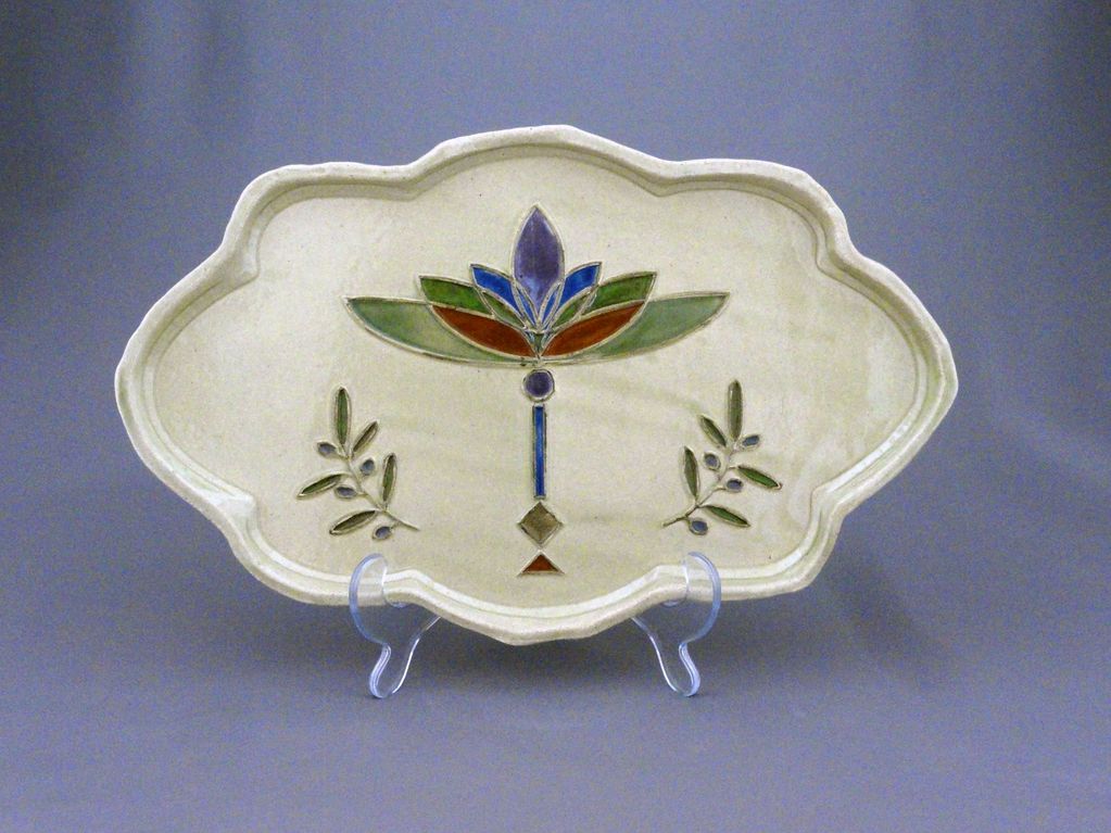 Serving plate with olive branch and tulip menorah. Challah  or holiday foods. Colorful.