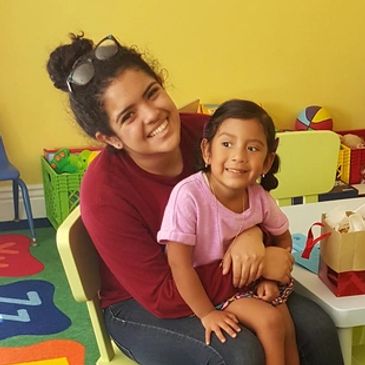 Alexxa, daughter of Happy Hearts' owner Rocio, sits with Rocio's niece Gianna on her lap.
