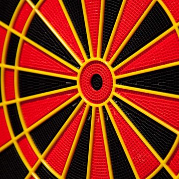 Close-up of a colorful dartboard with red, black, and yellow sections.