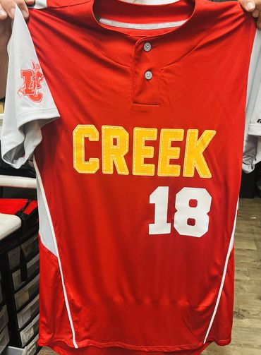 Red and white sports jersey with 'CREEK' and number 18.