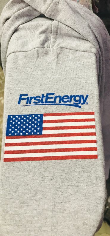 Gray fabric with FirstEnergy logo and American flag printed on it.