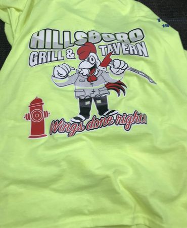 Bright yellow shirt with Hillsboro Grill & Tavern logo and slogan.