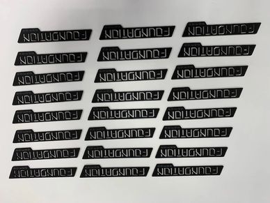Multiple black labels with the word 'FOUNDATION' printed in white.