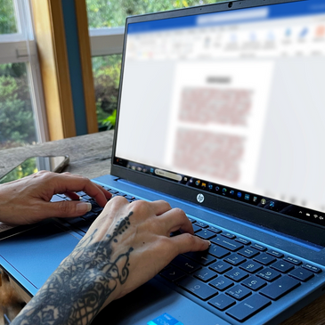 Doctor reviewing medical records on a computer screen.